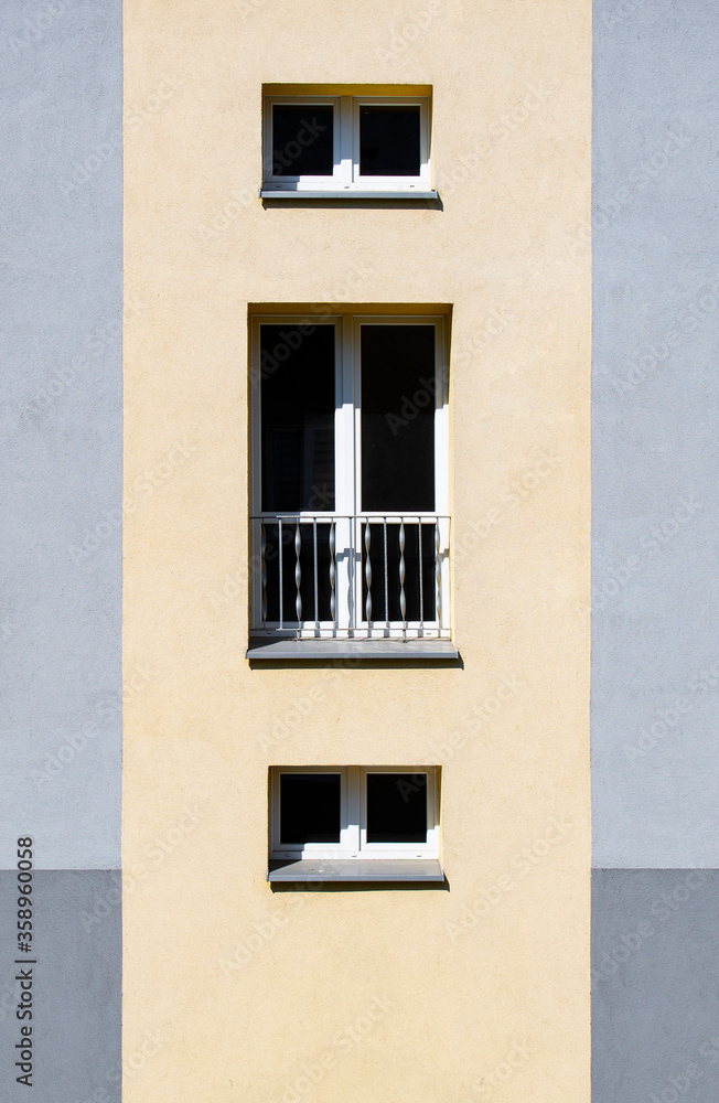 Yellow / gray facade of a building. Block of flats.