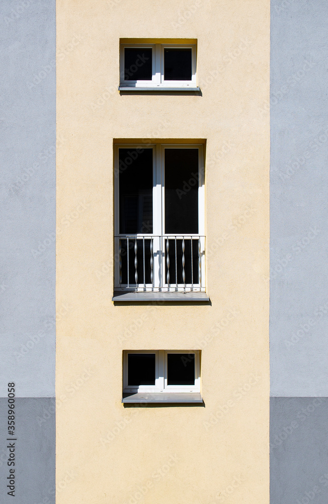 Yellow / gray facade of a building. Block of flats. Yellow / gray facade of a building. Block of flats.