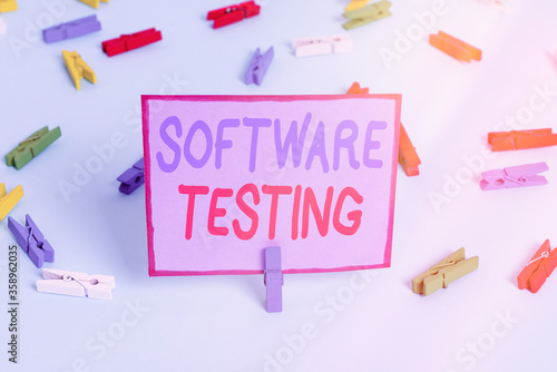 Writing note showing Software Testing. Business concept for activity to check whether the results match the expected Colored clothespin papers empty reminder blue floor officepin photo