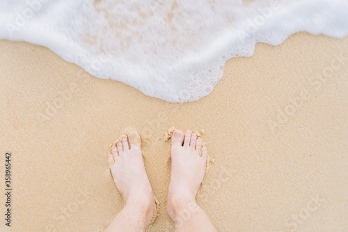 feet standing on the beach, summer time