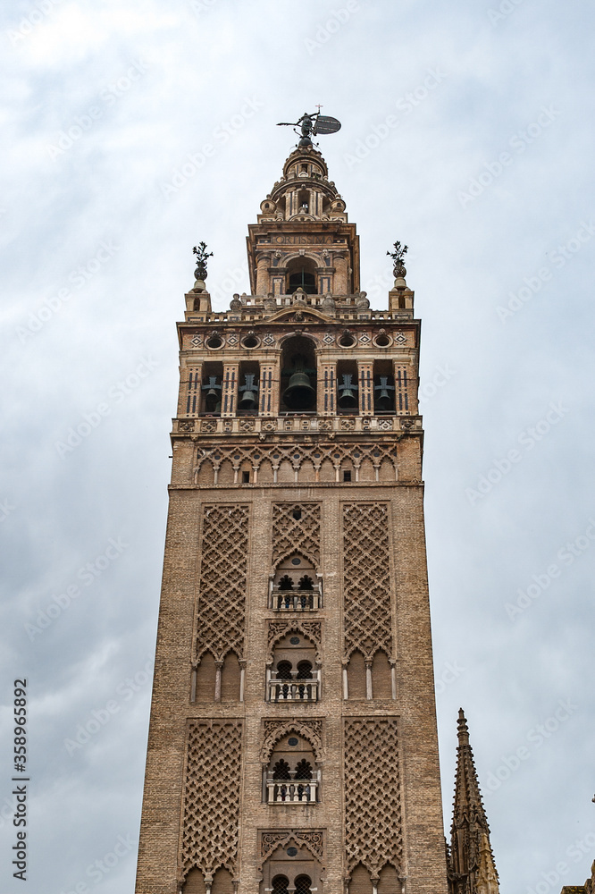 It's Giralda, a former minaret that was converted to a bell tower for the Cathedral of Seville in Seville. UNESCO World Heritage