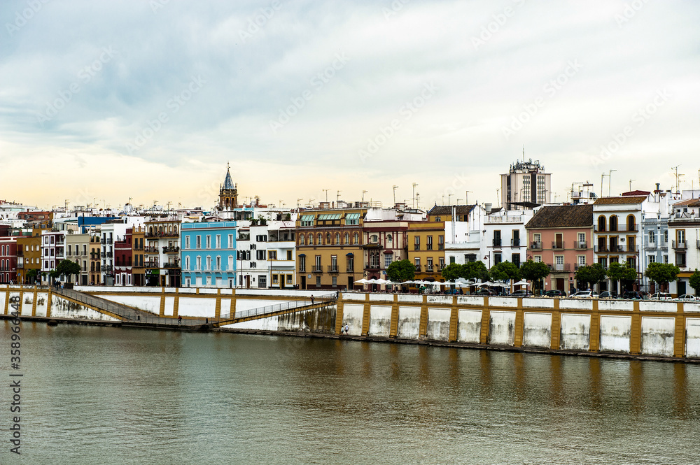 It's Guadalquivir river coast and architecture of Seville, Andalusia, Spain.