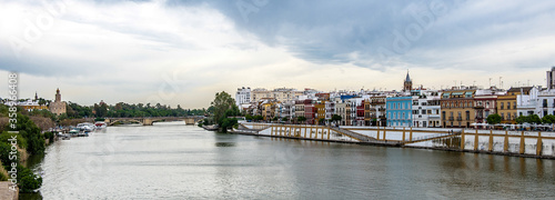 It's Guadalquivir river coast and architecture of Seville, Andalusia, Spain.