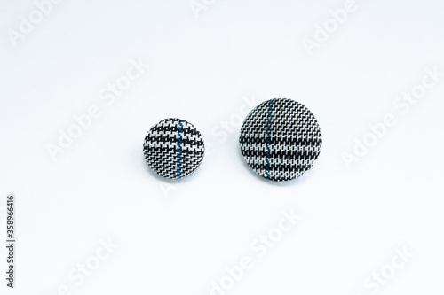 button for clothes made of fabric on white