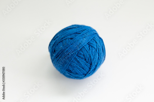 ball of blue thread on a white background