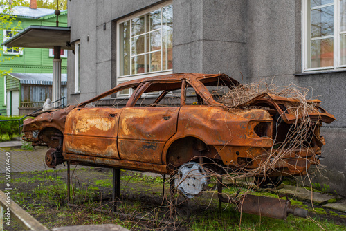 Parnu (Pärnu)/ Estonia - May 14 2020: Abandoned Audi wreck rusting in the city street. Wrecked Audi, smashed and burned automobile.