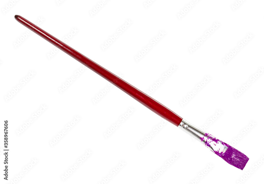 flat paint brush with purple colored tip and brown handle isolated on white background flat paint brush with purple colored tip and brown handle isolated on white background