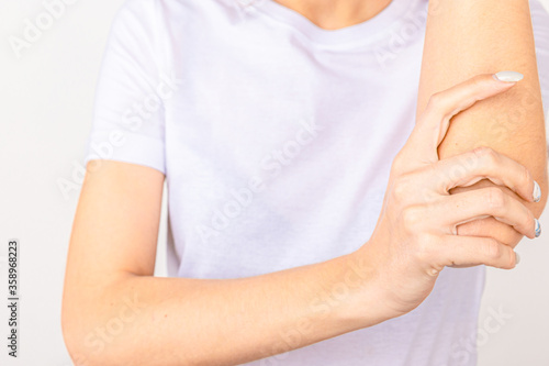 Woman suffering from chronic joint rheumatism. Elbow pain and treatment concept