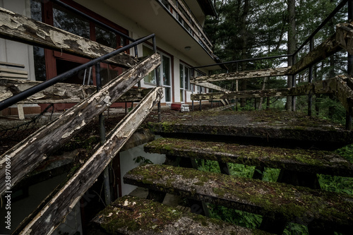 Stairs leading to one of the buildings in the abandoned resort located in the middle of the forest