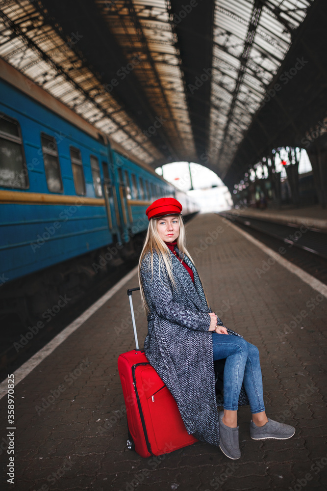 Fototapeta premium Lady in a red cap and with a red bag, urban geometry.