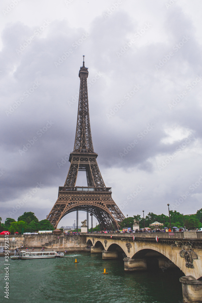 The eiffel tower on a cloudy day, in Paris, France.