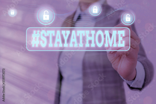 Conceptual hand writing showing Hashtag Stay at home. Concept meaning a trending label in social media related to the coronvirus outbreak Graphics padlock for web data security application system photo