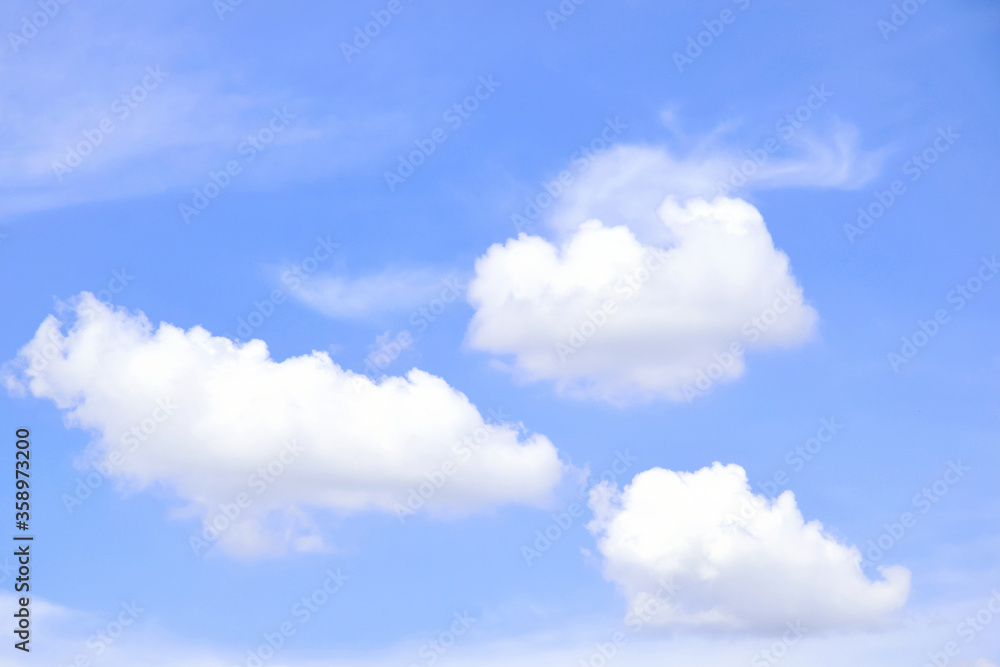 Blue sky with three separate clouds Blue sky with three separate clouds