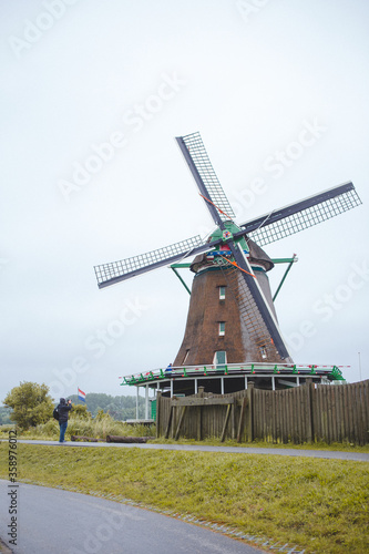 Windmills in Zaanse Schans village  near the sea coast  on a cloudy day.