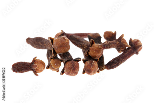 Cloves spice. Some dried cloves, macro close-up Isolated on white background, with a light shadow.