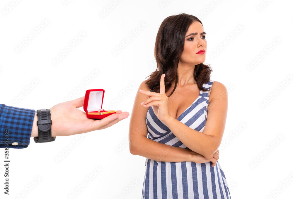 Portrait of nice caucasian girl holds a little box with a ring isolated on white background Portrait of nice caucasian girl holds a little box with a ring isolated on white background