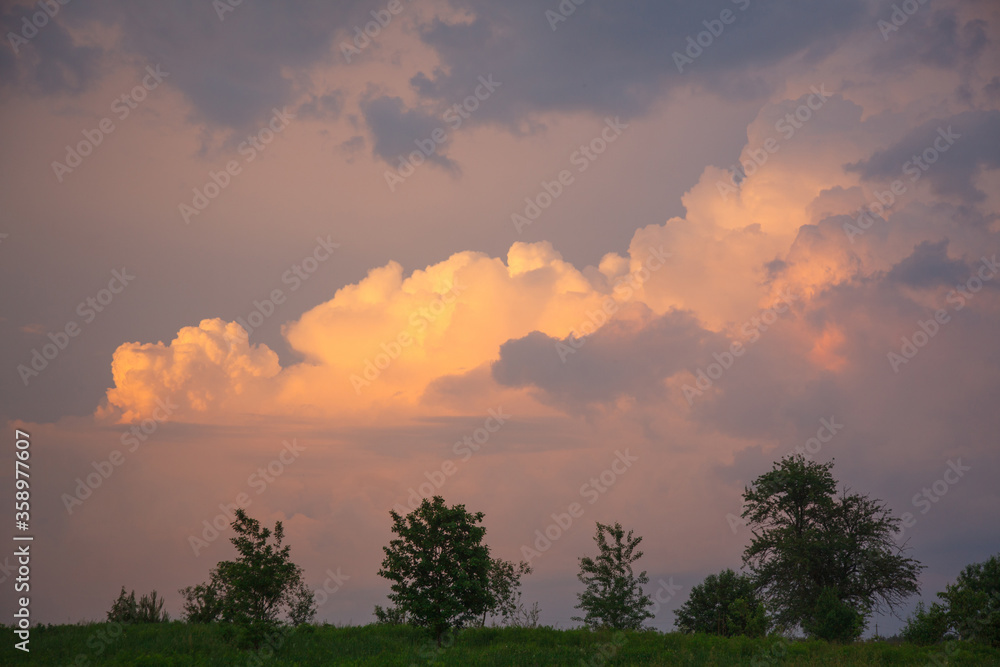 Fototapeta premium landscape with sunset and cumulus clouds