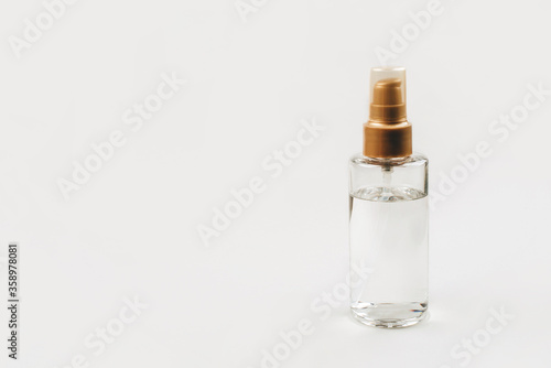 A bottle with a cosmetic product for skin or hair care. Copy space for text.