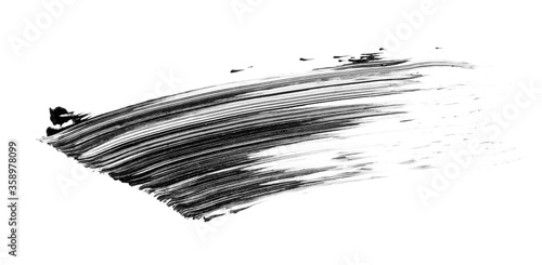 Black mascara or paint brush stroke isolated on white background photo