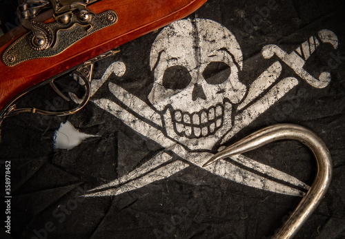 black pirate flag jolly roger pistol and steel sharp hook