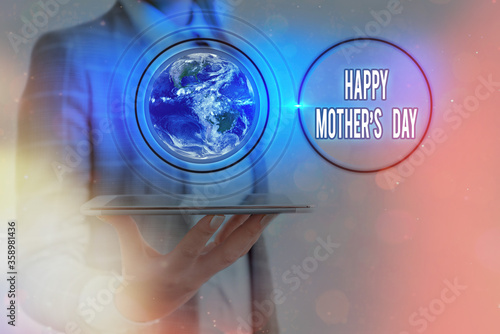 Writing note showing Happy Mothers Day. Business concept for celebrated in honor of the motherhood s is influence in society Elements of this image furnished by NASA photo