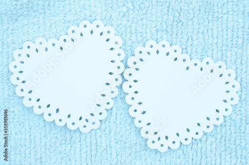 Two blue hearts on pale blue plush lined fabric background
