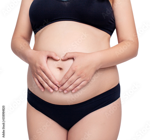 Wallpaper Mural Pregnant woman holds hands in heart shape on her belly in black lingerie. Torontodigital.ca