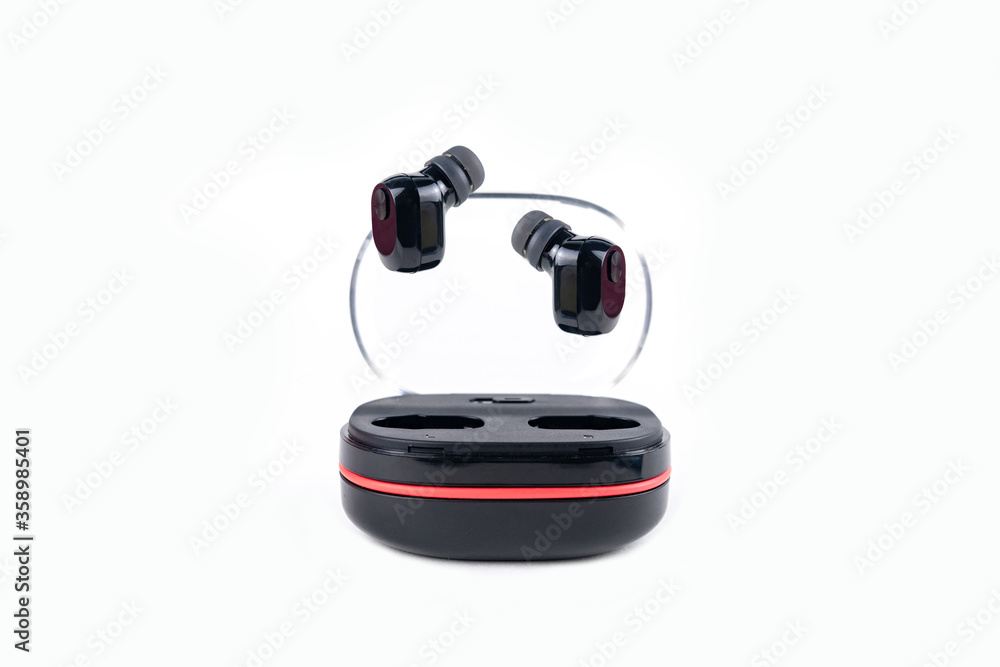 two compact black vacuum wireless headphones flying above the container box two compact black vacuum wireless headphones flying above the container box