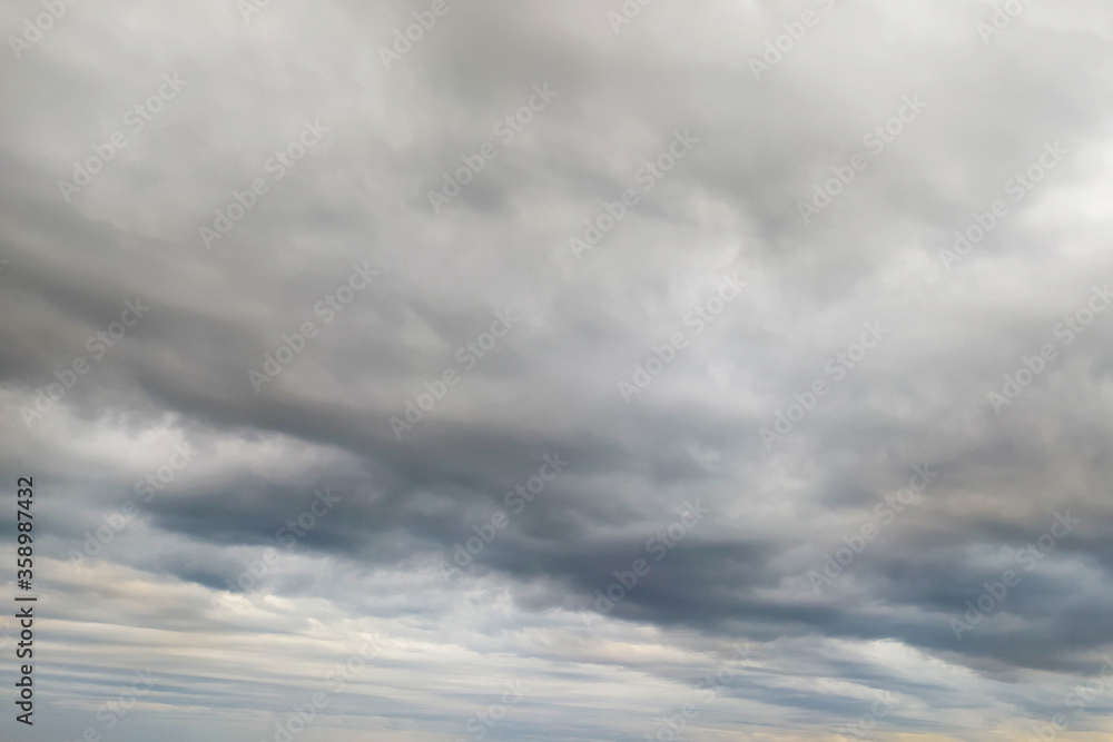 Dramatic sky with gray and lead clouds. Cloudy weather before the rain. Overcast. The concept of weather and climate.