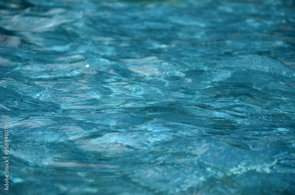 Clear and transparent water in the pool, water texture background.