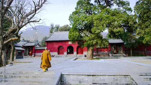 Monk walks into the building. Shaolin Monastery, Shaolin Temple. Dengfeng, Zhengzhou, Henan, China
