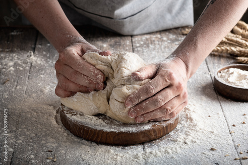 baker's hands make dough