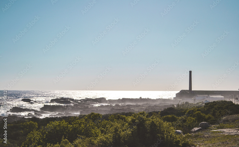 Lighthouse agains a misty ocean background