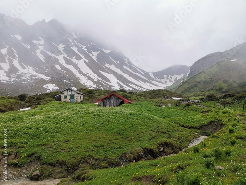 Hiking path between fiderepass hut and mindelheimer hut in the bavarian alps on a wet rainy spring day photo