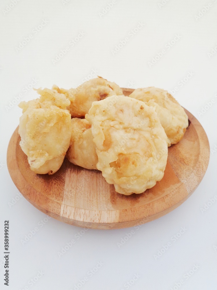 Fried fermented cassava, Indonesian famous street food or street snack. Indonesian called tape goreng, rondo royal or fried peuyeum. Sweet, creamy, crunchy outside, little oily and delicious. Fried fermented cassava, Indonesian famous street food or street snack. Indonesian called tape goreng, rondo royal or fried peuyeum. Sweet, creamy, crunchy outside, little oily and delicious.