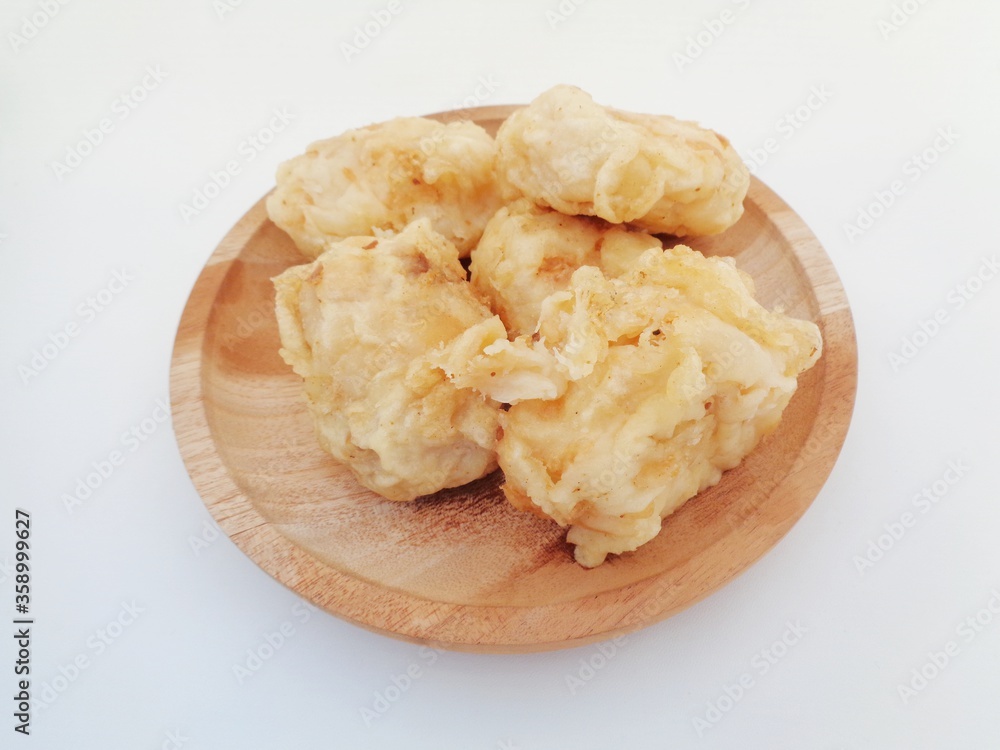 Fried fermented cassava, Indonesian famous street food or street snack. Indonesian called tape goreng, rondo royal or fried peuyeum. Sweet, creamy, crunchy outside, little oily and delicious. Fried fermented cassava, Indonesian famous street food or street snack. Indonesian called tape goreng, rondo royal or fried peuyeum. Sweet, creamy, crunchy outside, little oily and delicious.