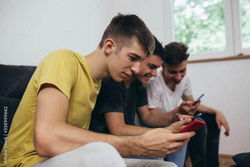 teenager boy using mobile phone at home teenager boy using mobile phone at home