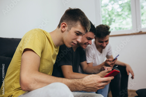teenager boy using mobile phone at home