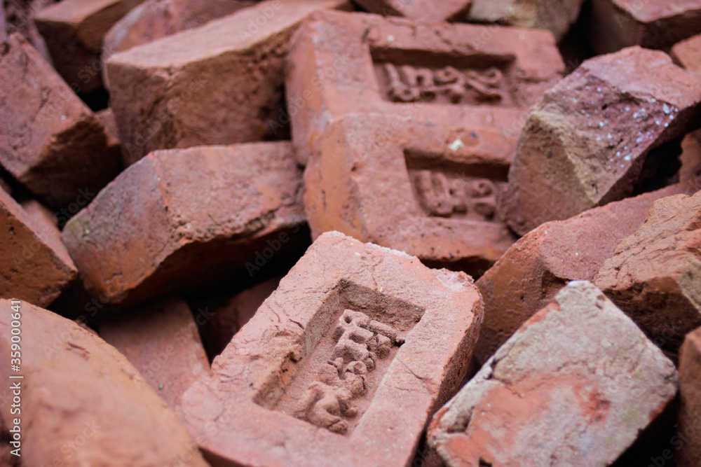 Red Bricks with Inscriptions in Hindi Alphabet. Construction Materials in India Red Bricks with Inscriptions in Hindi Alphabet. Construction Materials in India