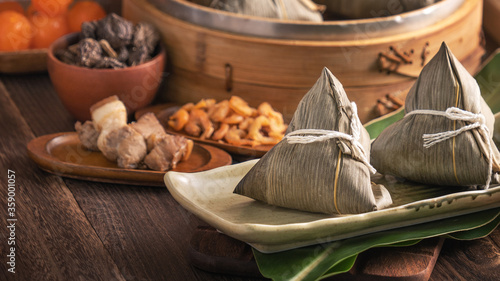Photography Rice dumpling - Chinese zongzi food in a steamer on wooden table with red brick wall, window background at home for Dragon Boat Festival concept, close up