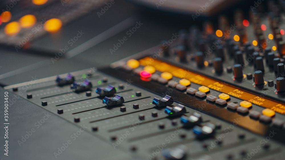 Modern Music Record Studio Control Desk with Equalizer, Mixer and other Professional Equipment. Switchers, Buttons, Faders, Sliders, Motorized Faders Move, Record, Play Hit Song. Close-up 