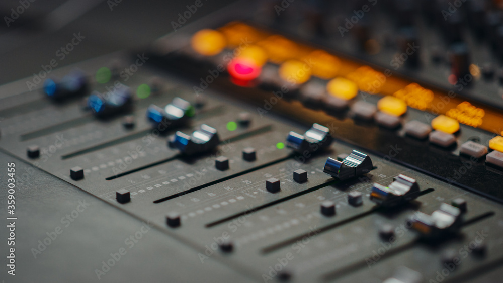 Modern Music Record Studio Control Desk with Automatic Equalizer, Mixer and other Professional Equipment. Switchers, Buttons, Faders, Sliders, Motorized Faders Move, Record, Play Hit Song. Close-up 