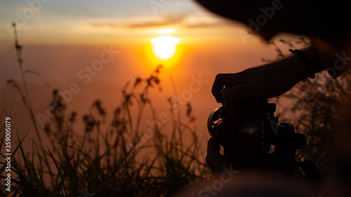 A photographer photographs the dawn of the sun on the volcano Batur. Bali Indonesia