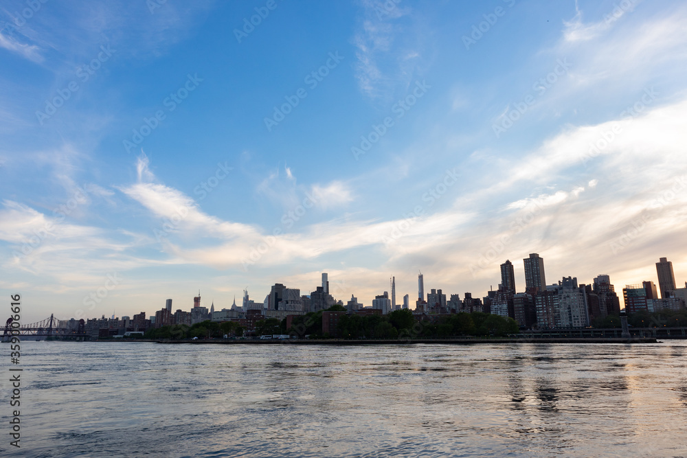 Colorful Sunset over the Roosevelt Island and Manhattan Skyline along the East River in New York City