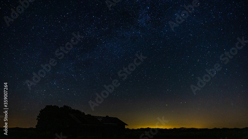 Starry filled sky with an abandoned barn in the foreground