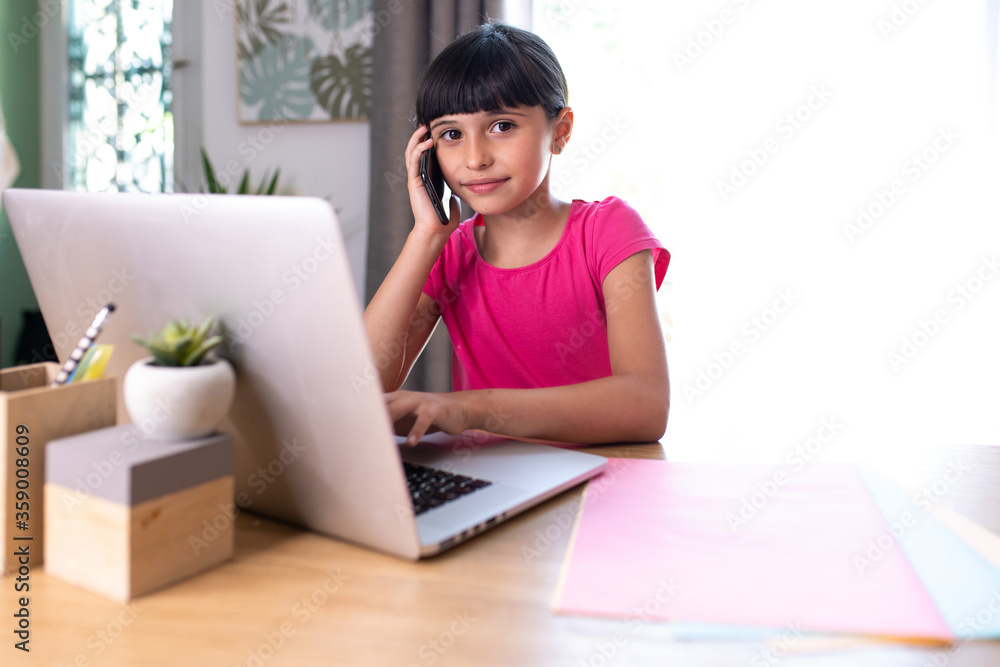 daughter imitating mom telecommuting with cellphone and computer daughter imitating mom telecommuting with cellphone and computer