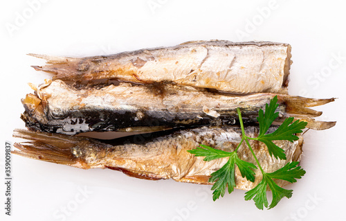 sprats with a sprig of fresh parsley isolated on a white background