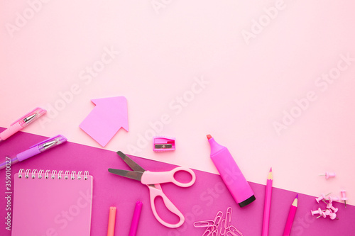 School supplies on pink background with copy space. Back to school. Flat lay.