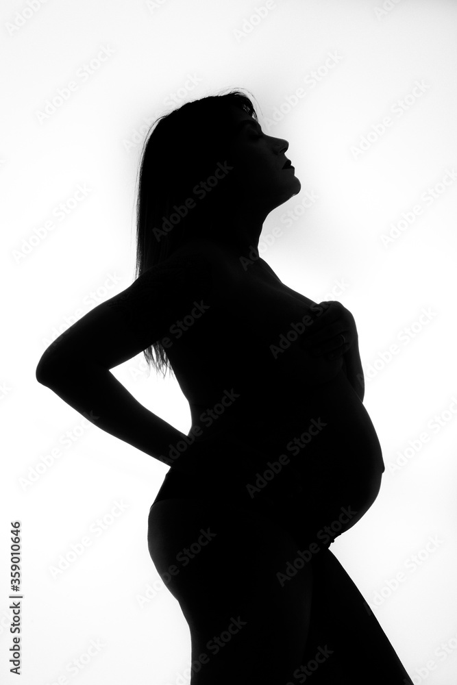 Pregnant woman taking photographs in photo shoot