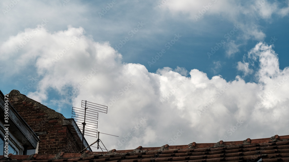 cloudy sky over a rooftop cloudy sky over a rooftop